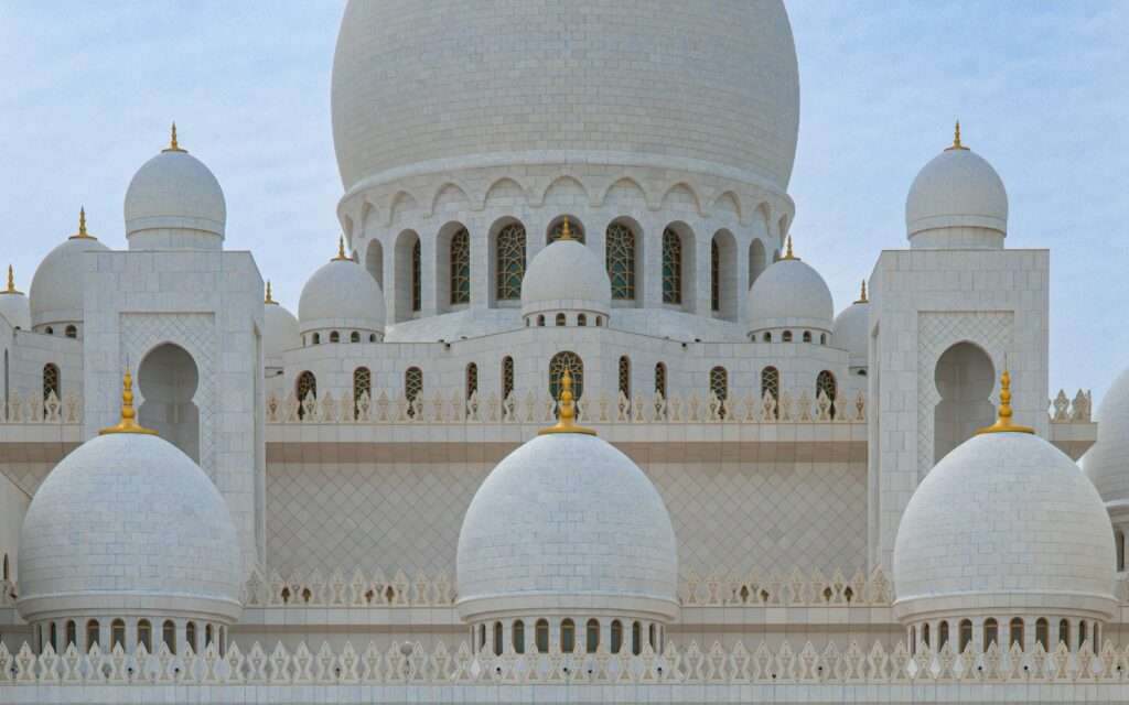 The white marble domes of Sheikh Zayed Grand Mosque in Abu Dhabi